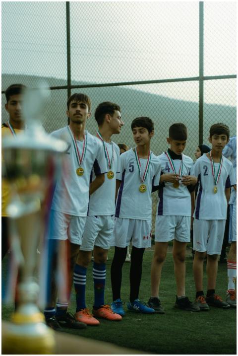Teenage soccer team in Erbil celebrating victory w