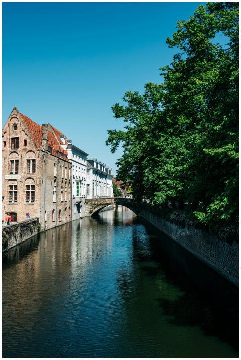 Charming canal view in Bruges featuring historic b