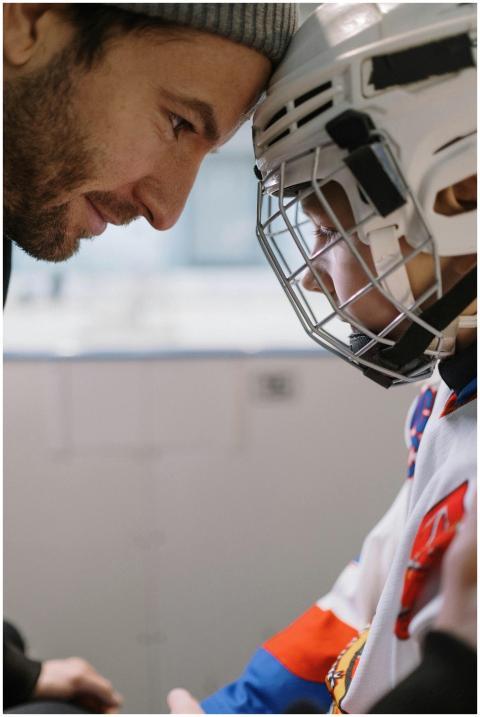 A father encourages his young son before an ice ho