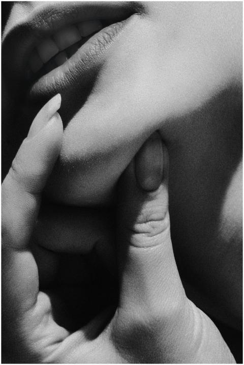 Black and white close-up of a woman's face with fi