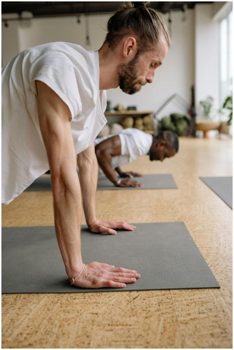 Two men focus on fitness with push-ups on yoga mat