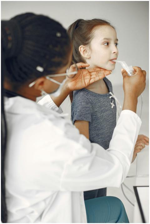 A girl receives a treatment from a medical profess