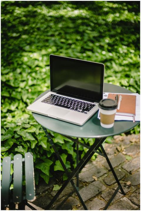 From above of modern laptop placed on round table