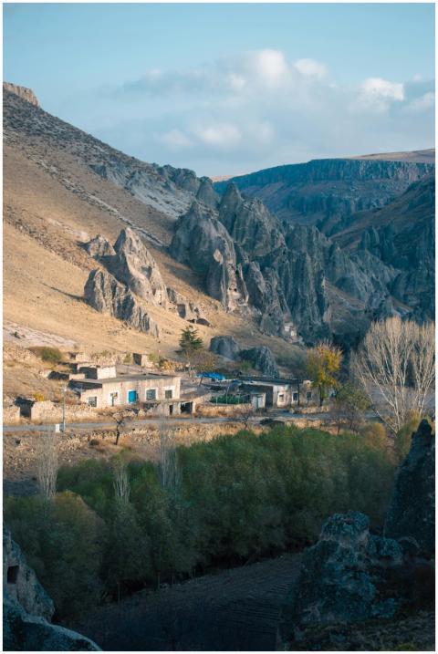 Picturesque mountain village with striking rock fo