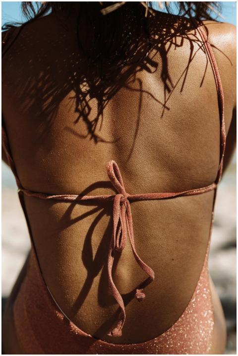 A relaxing beach day showing a woman in a swimsuit