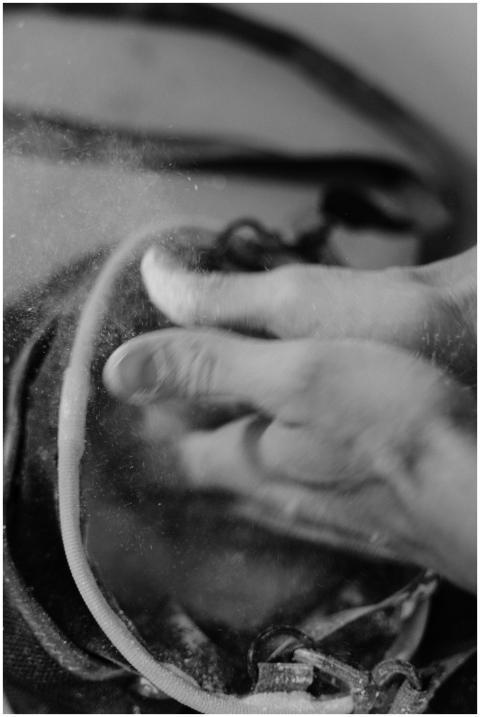 Black and white photo of hands applying chalk dust