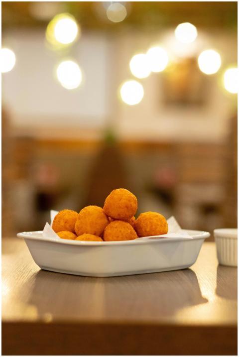 Golden cheese balls served in a rustic indoor sett
