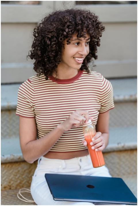 Happy young ethnic female student with curly hair