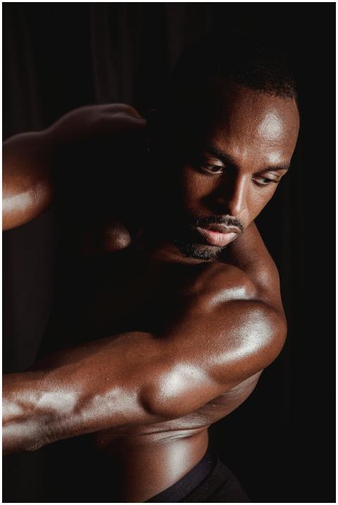 Portrait of a muscular man posing shirtless, highl