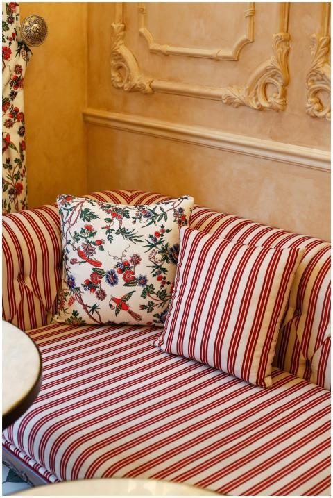 Cozy living room corner with striped sofa and flor