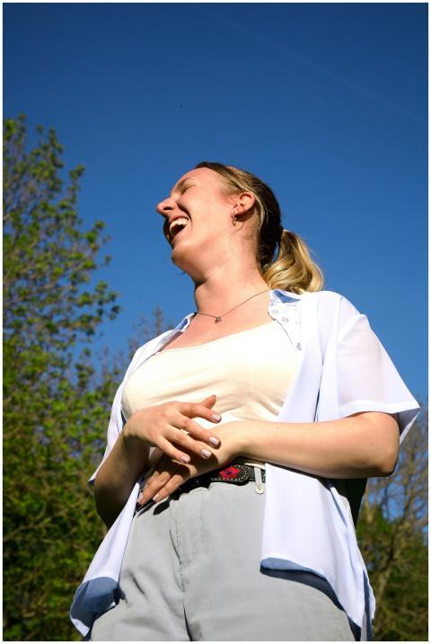 Smiling woman enjoying a sunny day outdoors, expre