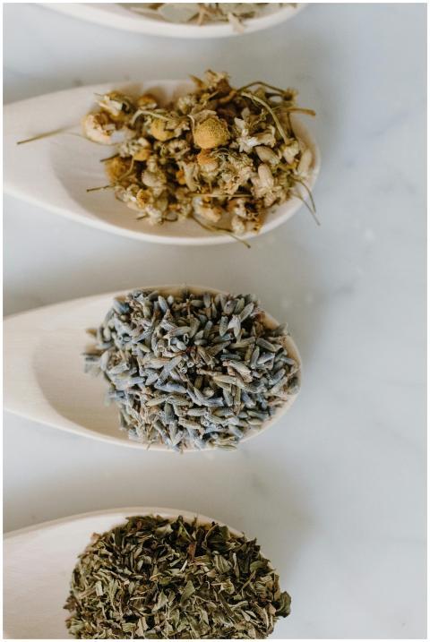 Flat lay of wooden spoons with chamomile, lavender