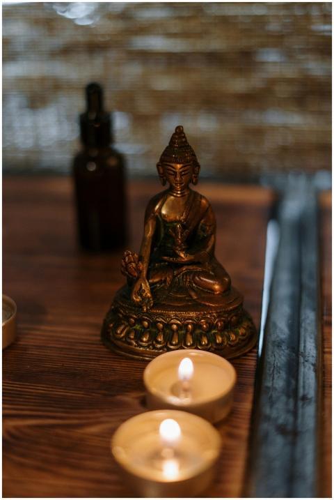 Buddha statue with candles creating a serene spa a