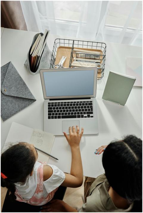Overhead view of a mother helping her daughter wit