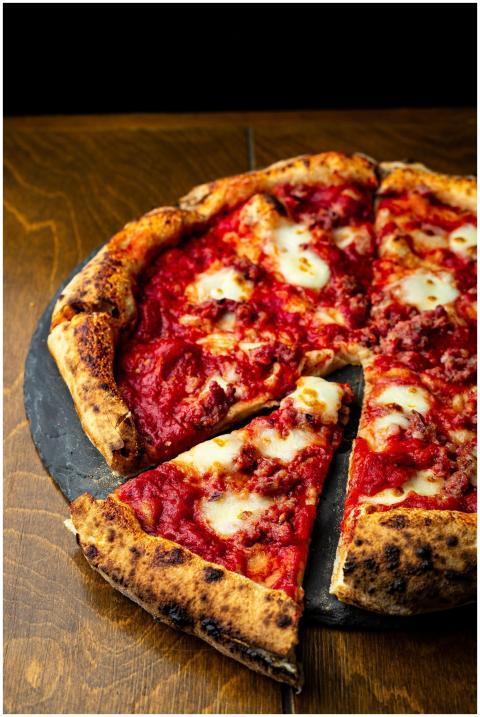 Tasty Neapolitan pizza with melted cheese and saus