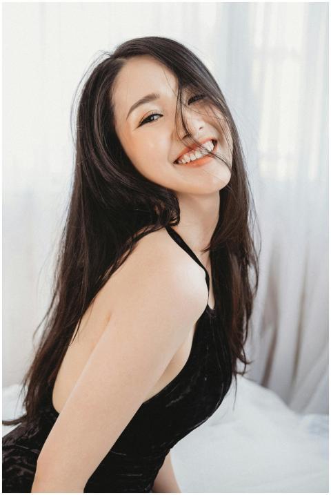 Cheerful woman in a black dress smiling brightly i