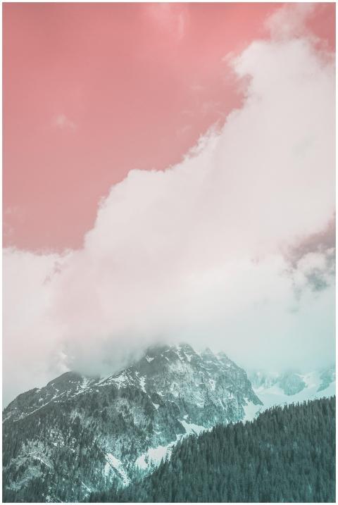 A scenic view of a snow-capped mountain beneath a