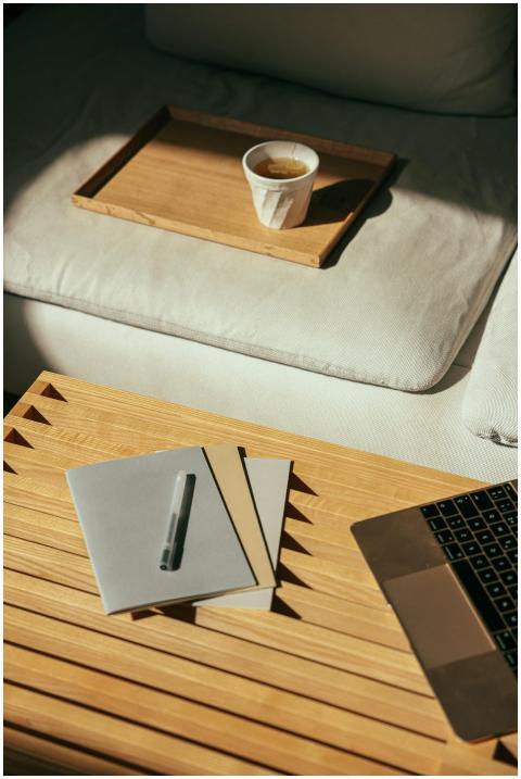 Warm indoor workspace scene with coffee, laptop, a