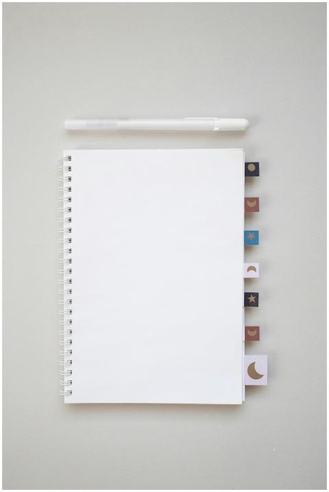 Simple flat lay of a spiral notebook with decorati