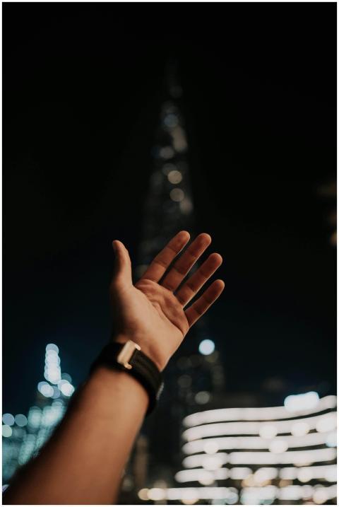 An outstretched hand reaching towards the illumina