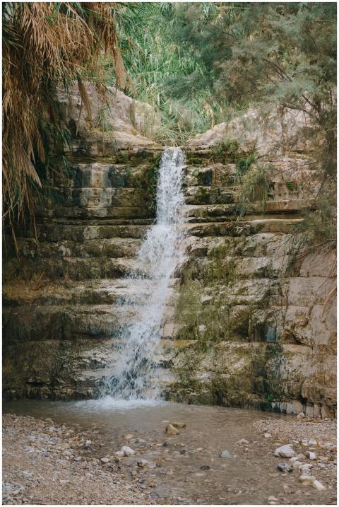 Peaceful waterfall cascading over rocks in the lus