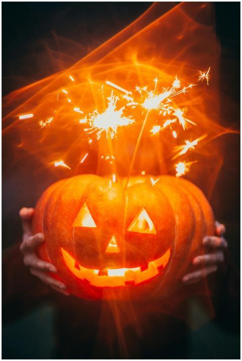 Glowing Halloween pumpkin with sparklers creating