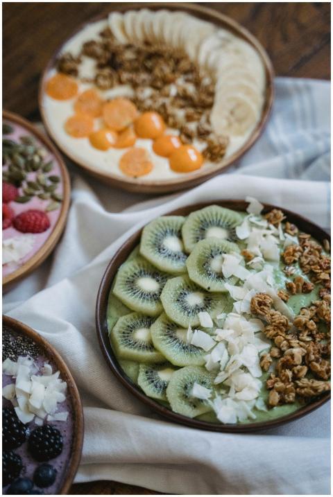 Three vibrant breakfast bowls with fresh fruits an