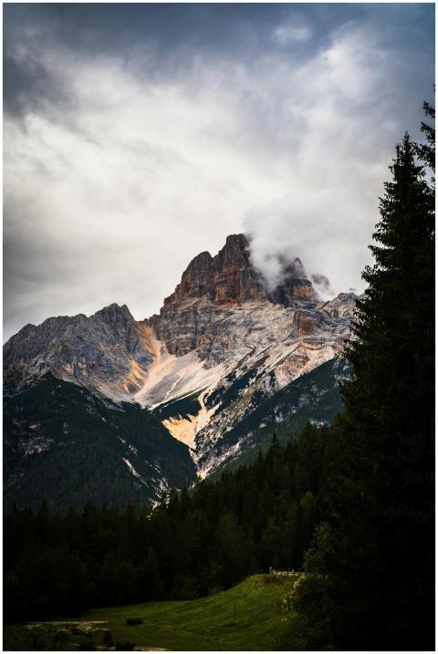 Stunning view of a mountain peak surrounded by tre