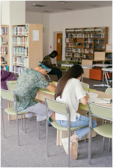 Adult students studying in a cozy university libra