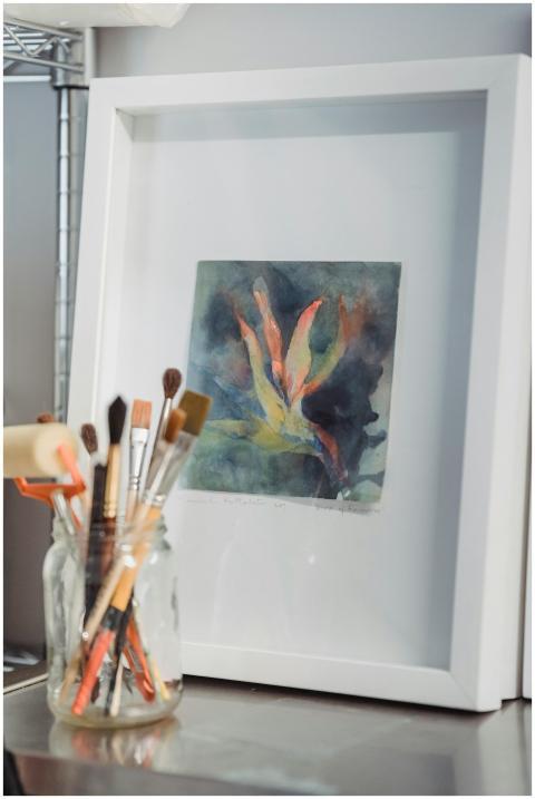 Framed abstract watercolor painting with paintbrus