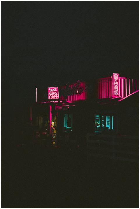 A retro diner illuminated by neon lights at night,