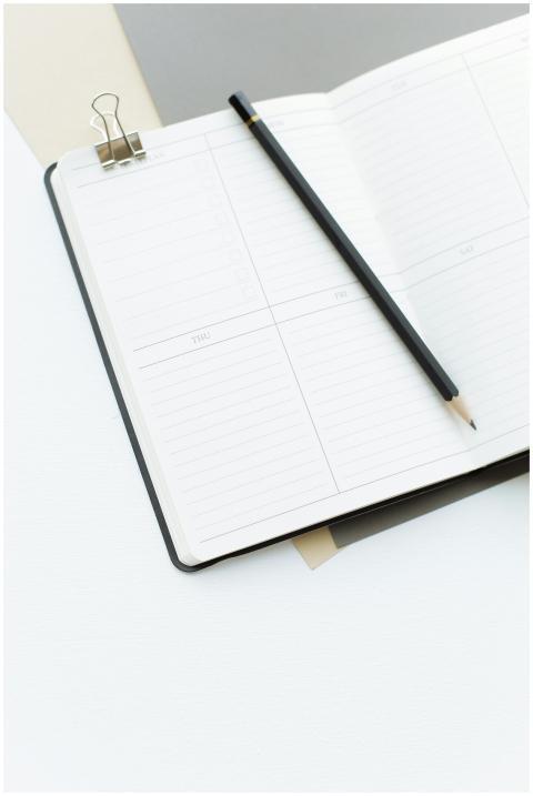 From above opened notebook with empty sheets and b