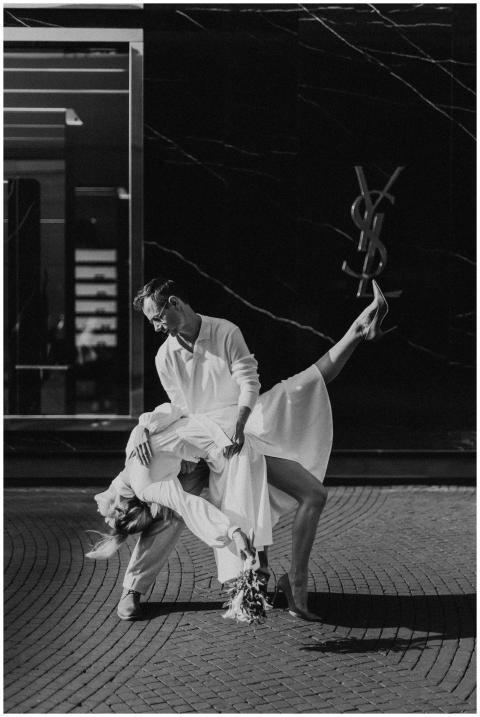 A couple dances gracefully in an elegant black and