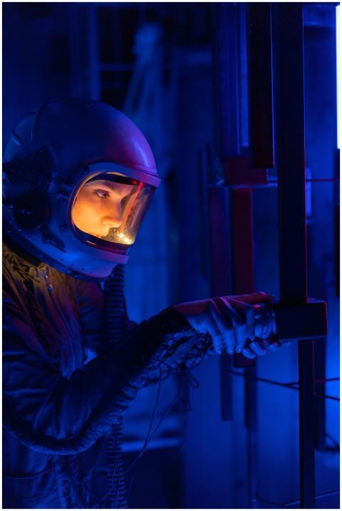 A woman astronaut in a spacesuit exploring a visua
