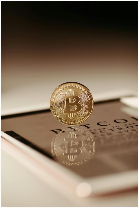 Close-up view of a Bitcoin coin reflecting on a ta