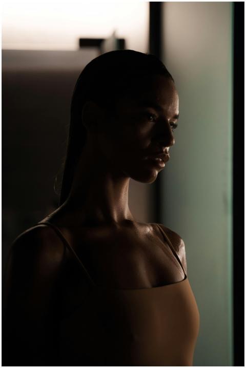 Artistic portrait of a young woman in a dimly lit