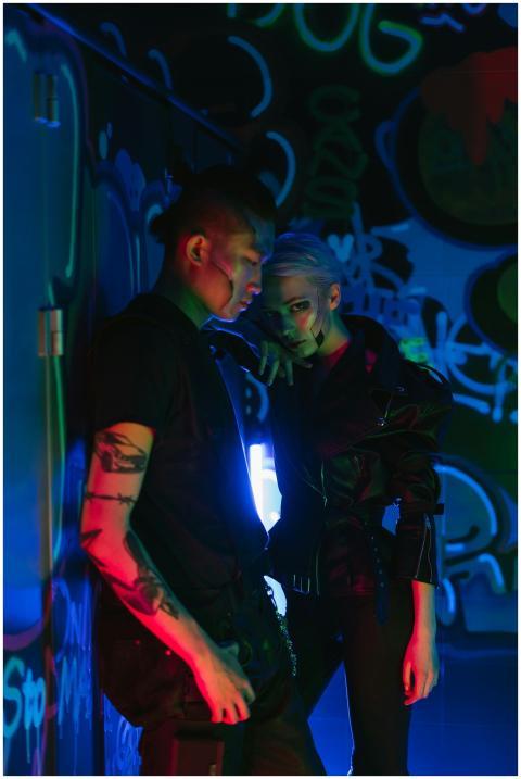 A stylish duo in futuristic cyberpunk attire and n