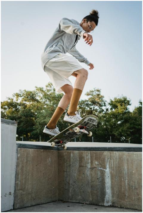 A young skateboarder in midair performing a trick