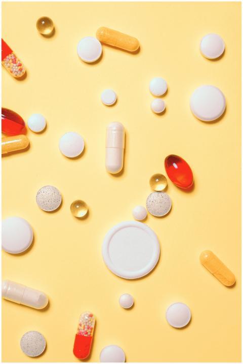 Colorful assortment of pills and capsules on a vib