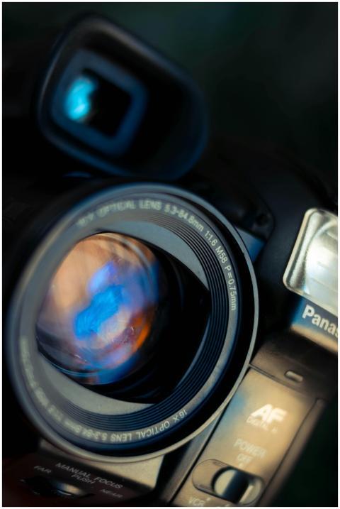 Detailed view of a professional camera lens with r