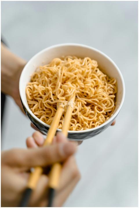 Close-up of a bowl of instant noodles being held w