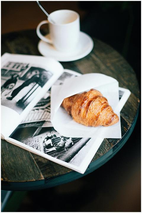 A cozy setup featuring a warm croissant and coffee