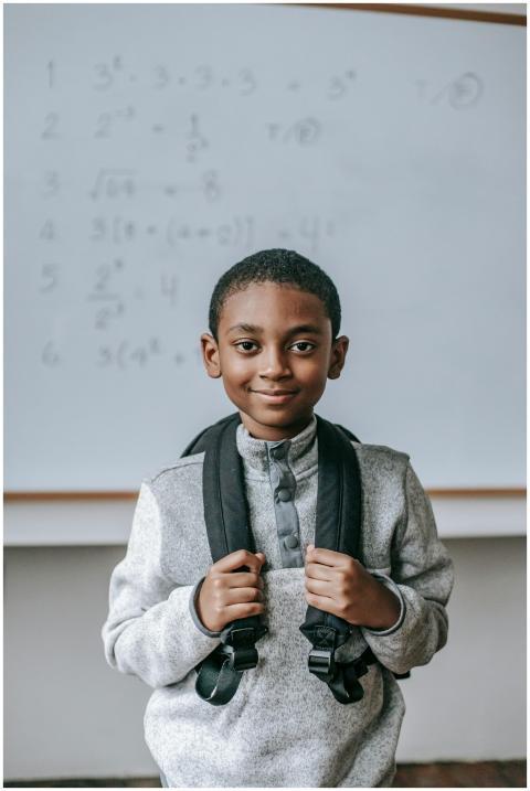 Cheerful African American boy in casual outfit wit