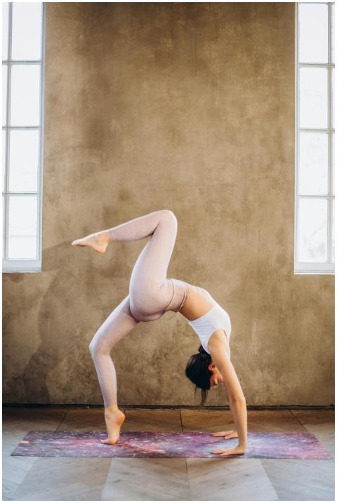 Woman performing a graceful wheel pose balancing o