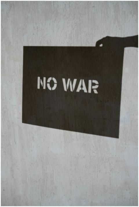 Shadow art depicting 'No War' message on a texture