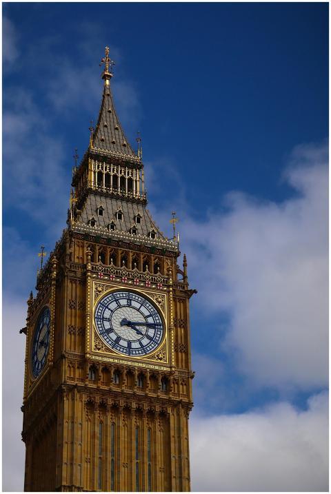 Iconic Big Ben clock tower against a vivid blue sk