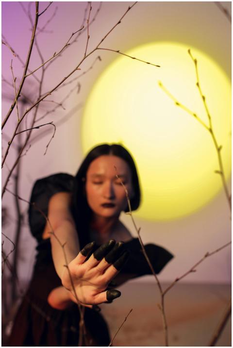 Artistic portrayal of a woman with a full moon bac