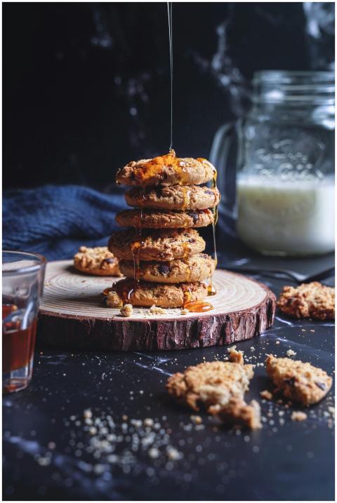 A stack of cookies with honey dripping, creating a