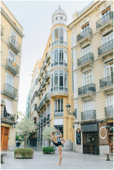 A young woman performs yoga in a picturesque Europ