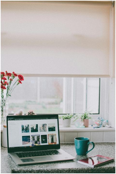 A cozy home office setup with a laptop, coffee mug